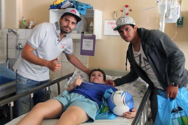 El delantero Sebastián Pinto y el defensa Nicolás Vargas compartiendo con uno de los niños internados en la sección Pediatría del Hospital Regional de Rancagua. 